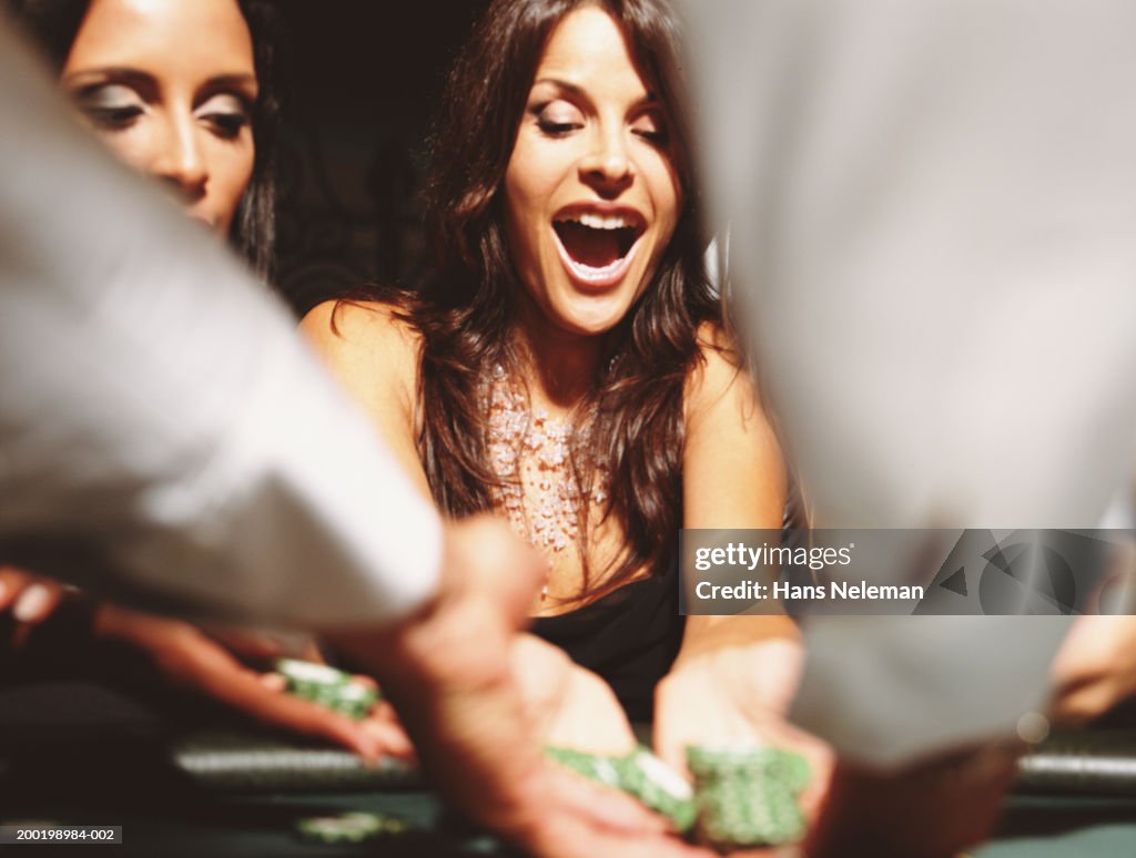 Two women at gaming table collection chips