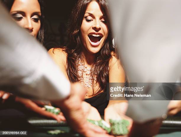 two women at gaming table collection chips - casino stock pictures, royalty-free photos & images