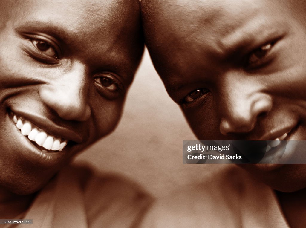 Two men smiling, close-up (sepia tone)