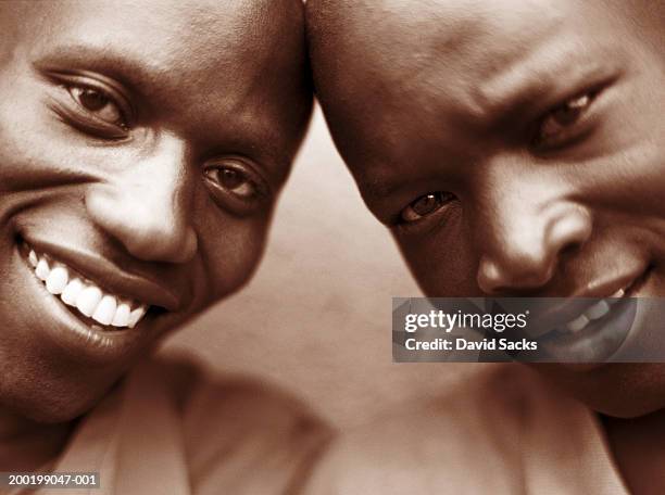 two men smiling, close-up (sepia tone) - east africa stockfoto's en -beelden
