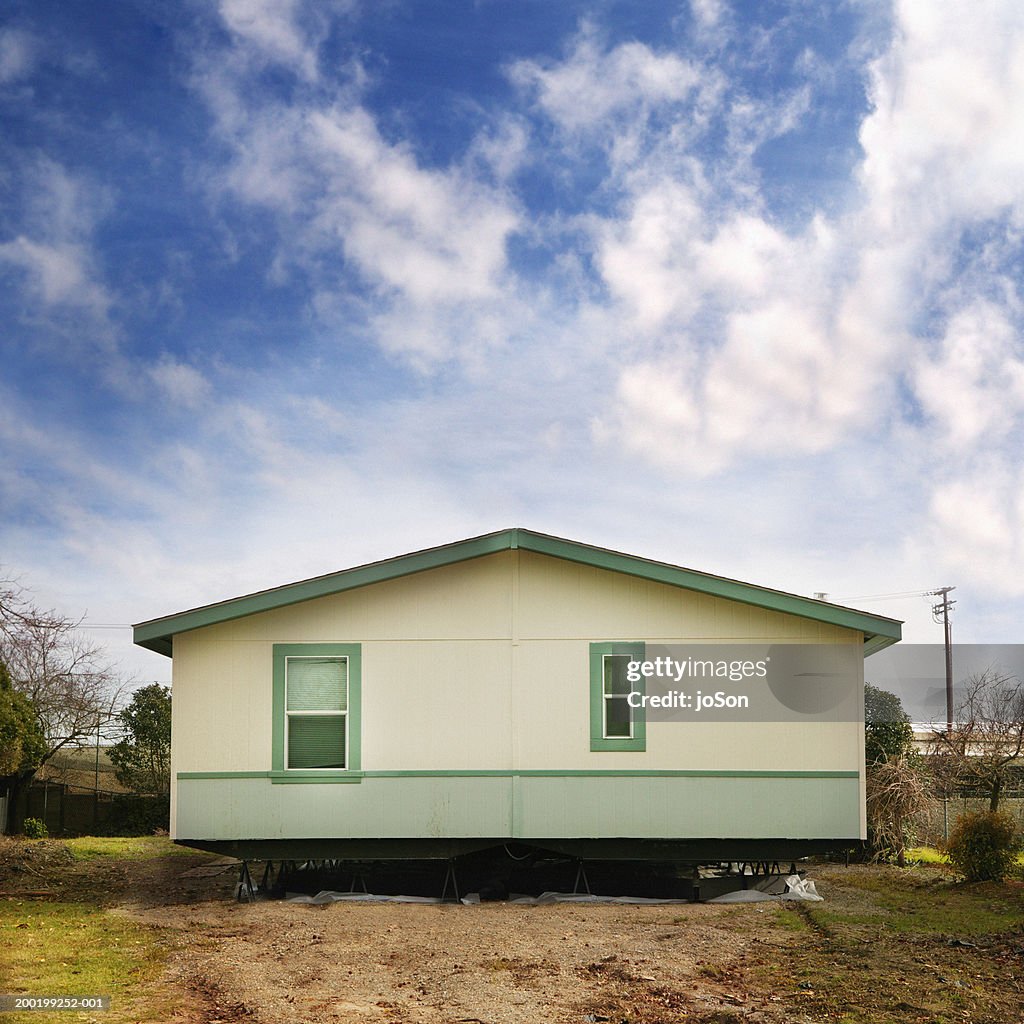 Prefabricated home on lot in process of being insulated