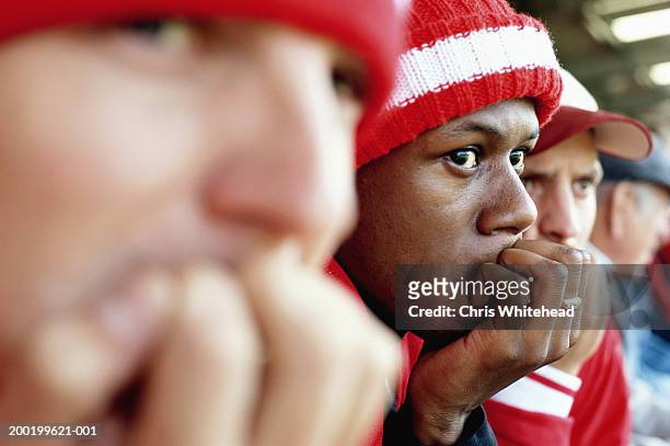 football supporters at match, biting nails, close-up - headshots soccer stock-fotos und bilder