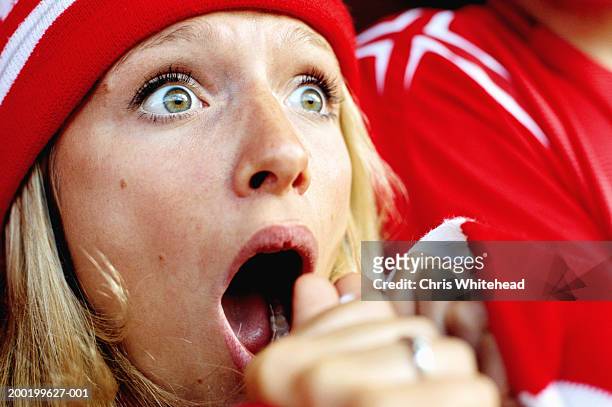 female football supporter at match, gasping, close-up - aufregung stock-fotos und bilder