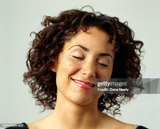 young woman with eyes closed, smiling, close-up - emotional series stock pictures, royalty-free photos & images