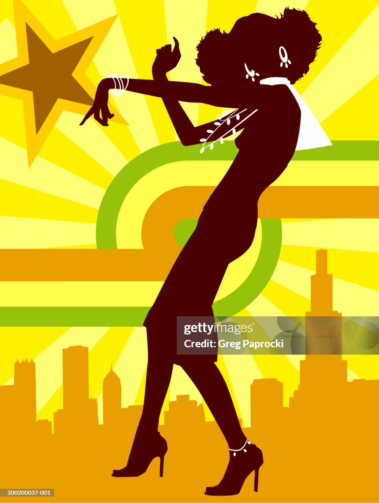 Silhouette of young woman dancing, cityscape in background