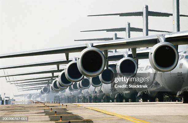 row of mcdonnell douglas c-17 globemaster iii planes on runway - war plane stock pictures, royalty-free photos & images