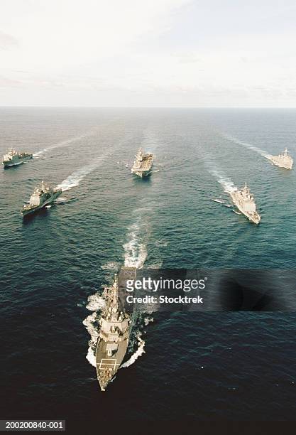 fleet of military ships at sea in atlantic ocean - navy blue photos et images de collection