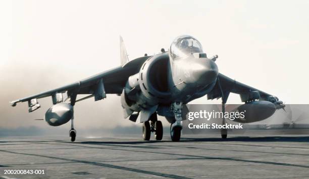 mcdonnell douglas av-8b harrier launching from aircraft carrier - aircraft carrier stock pictures, royalty-free photos & images