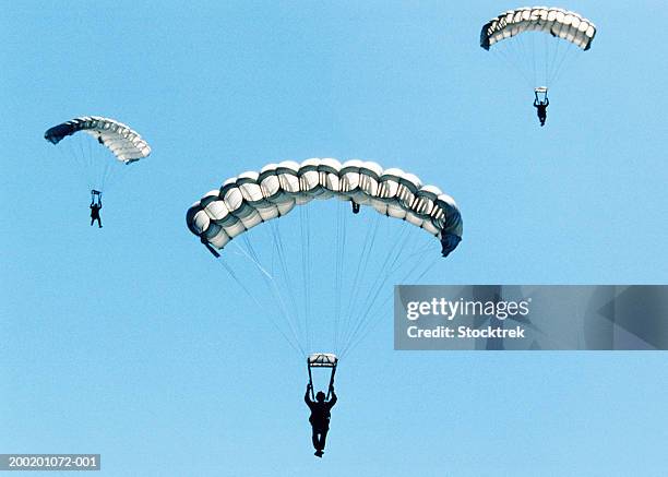 sailors and airmen parachuting during training exercise - paracadutista foto e immagini stock