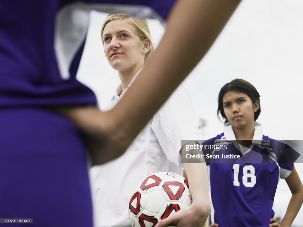 Teenage girl (16-18) staring at opponent on soccer field