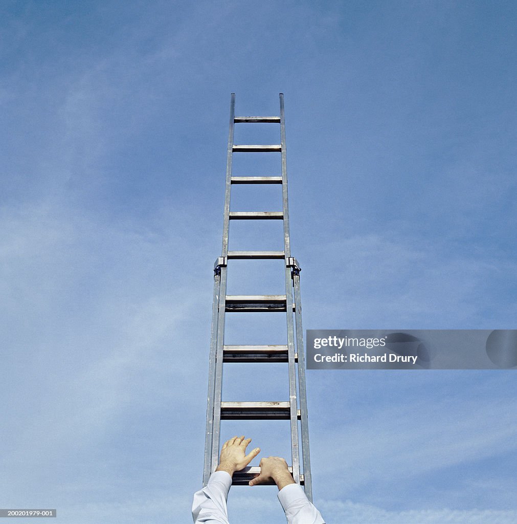 Man climbing ladder, reaching for rungs, outdoors, close-up