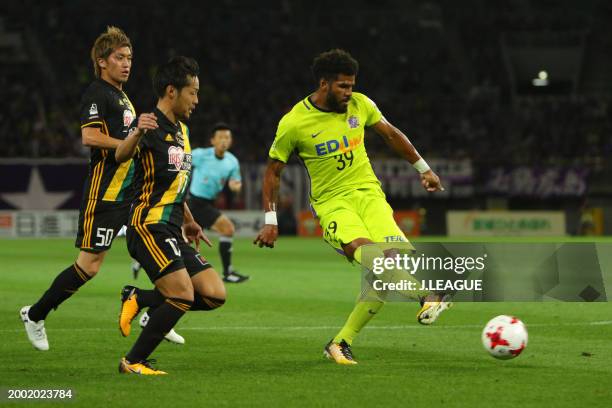 Patric of Sanfrecce Hiroshima controls the ball against Shingo Tomita and Tatsuya Masushima of Vegalta Sendai during the J.League J1 match between...