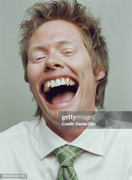 man smiling with mouth held wide open (digital enhancement) - inside human mouth stock pictures, royalty-free photos & images