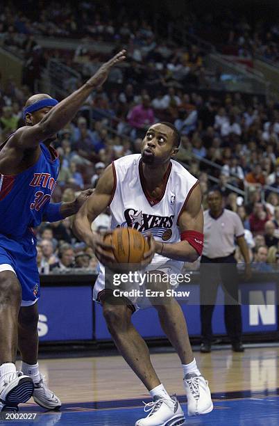 Kenny Thomas of the Philadelphia 76ers goes to the basket while being defended by Clifford Robinson of the Detroit Pistions in Game three of the...