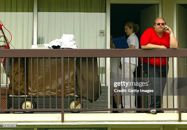 Texas Representative Dan Ellis talks on his cell phone outside his hotel room at the Holiday Inn May 15, 2003 in Ardmore, Oklahoma. Democratic...