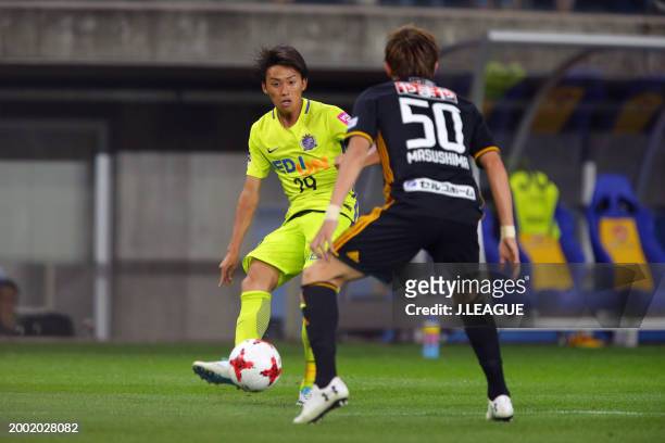 Tsukasa Morishima of Sanfrecce Hiroshima takes on Tatsuya Masushima of Vegalta Sendai during the J.League J1 match between Vegalta Sendai and...