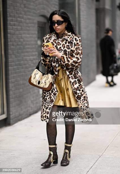 Guest is seen wearing an animal print coat, gold dress and black sunglasses outside the Proenza Schouler show during NYFW F/W 2024 on February 10,...