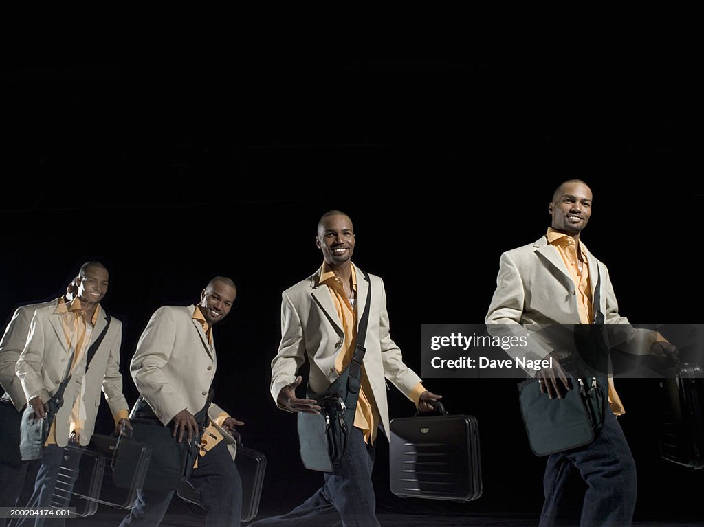Businessman carrying briefcase and light luggage