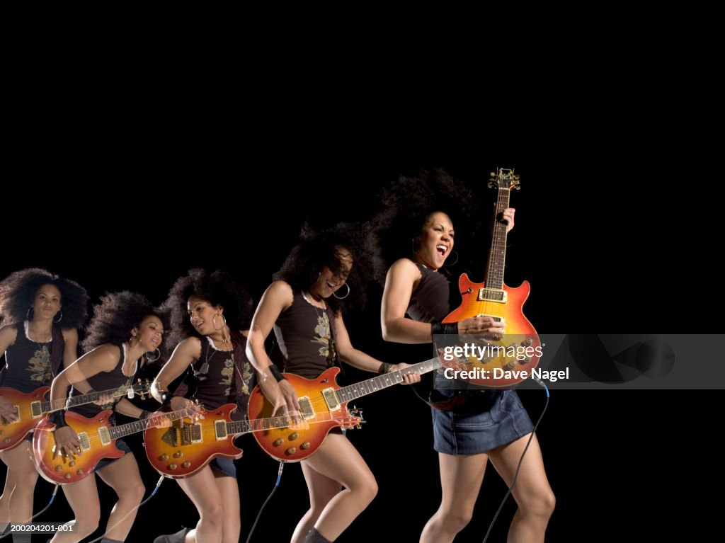 Young woman playing electric guitar