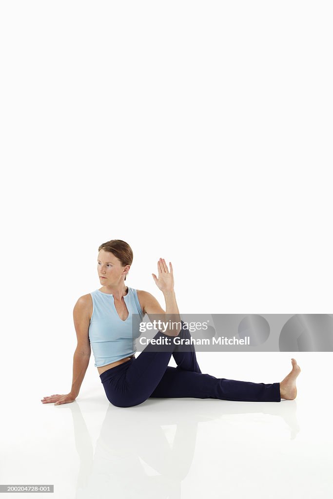 Woman doing yoga, seated spinal twist position