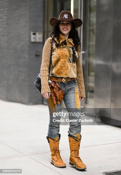 Guest is seen wearing a brown faux fur sweater, blue and brown patch jeans, brown cowboy boots and a brown cowboy hat outside the Proenza Schouler...