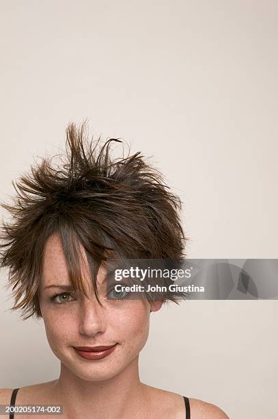 young woman smiling, raising eyebrow, close-up - spiked stock pictures, royalty-free photos & images