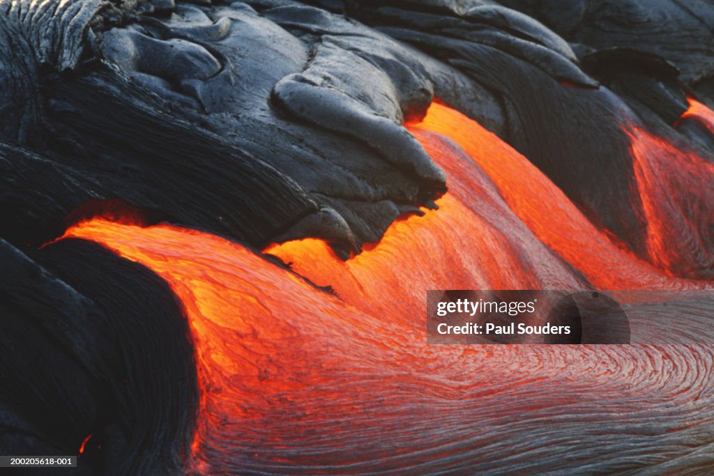 Glowing streams of lava pouring during eruption of Kilauea volcano