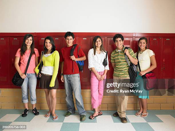 six teenagers (14-16) standing in front of lockers, smiling, portrait - boy skirt stock pictures, royalty-free photos & images