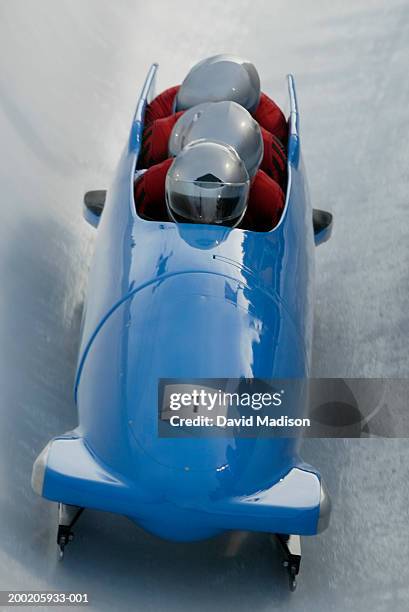 four-man bobsled running down track, close-up - bobsled stock pictures, royalty-free photos & images