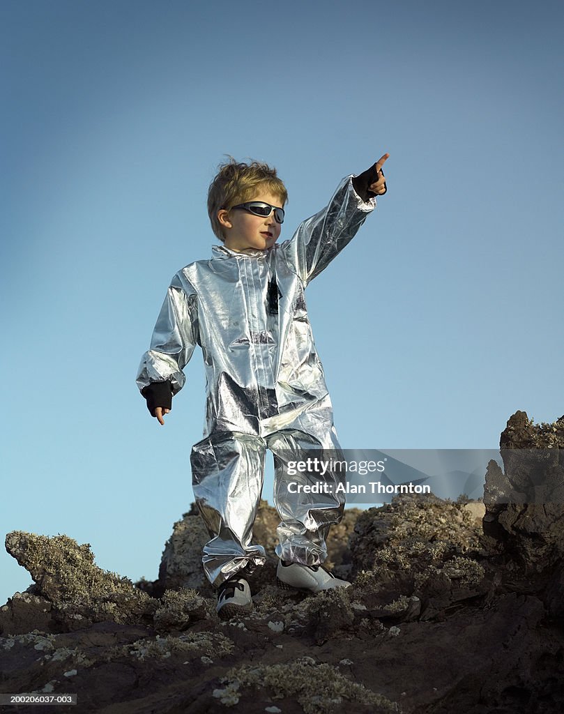 Canary Islands, Lanzarote, boy (3-5) in silver suit, pointing