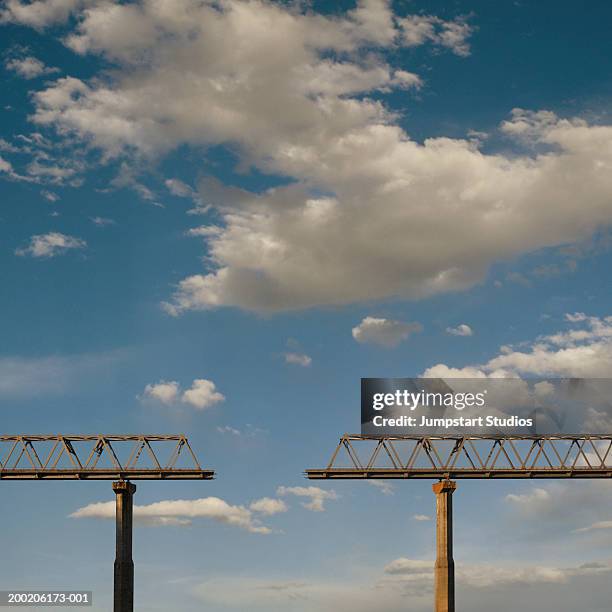 missing section in bridge against cloudy sky (digital composite) - bridging the gap stock pictures, royalty-free photos & images