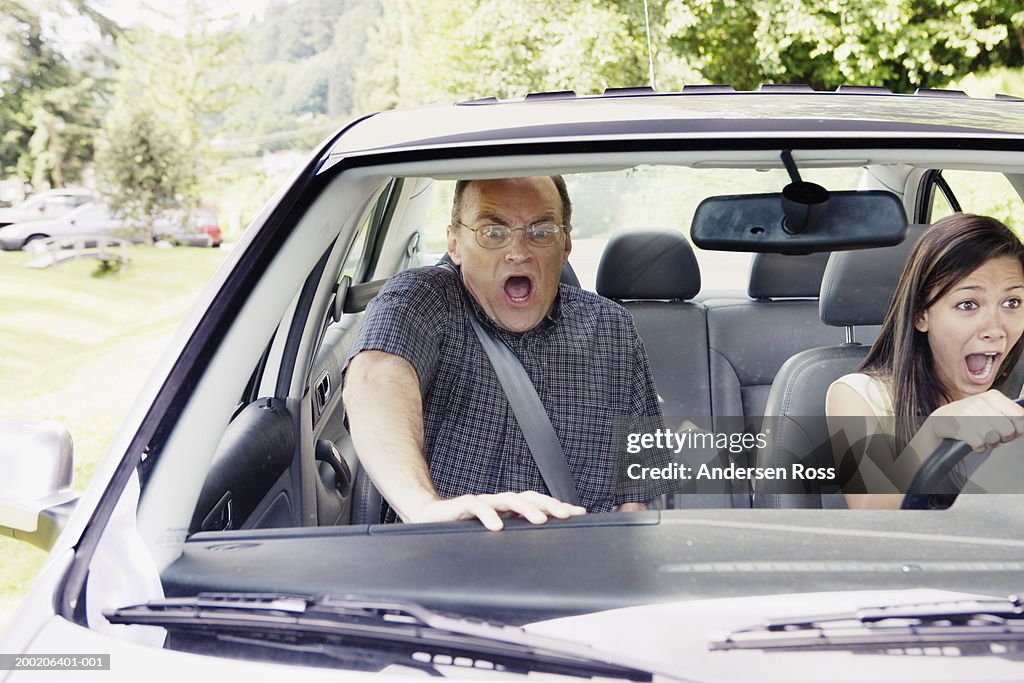 Teenage girl (14-16) and man screaming in car