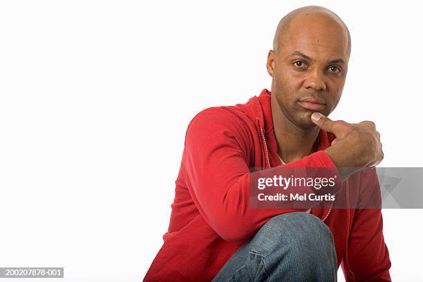 mature man resting chin on hand, portrait - black-jeans stock pictures, royalty-free photos & images