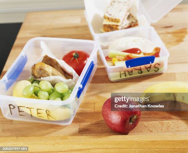 named packed lunches on table, close-up - sack lunch stock pictures, royalty-free photos & images