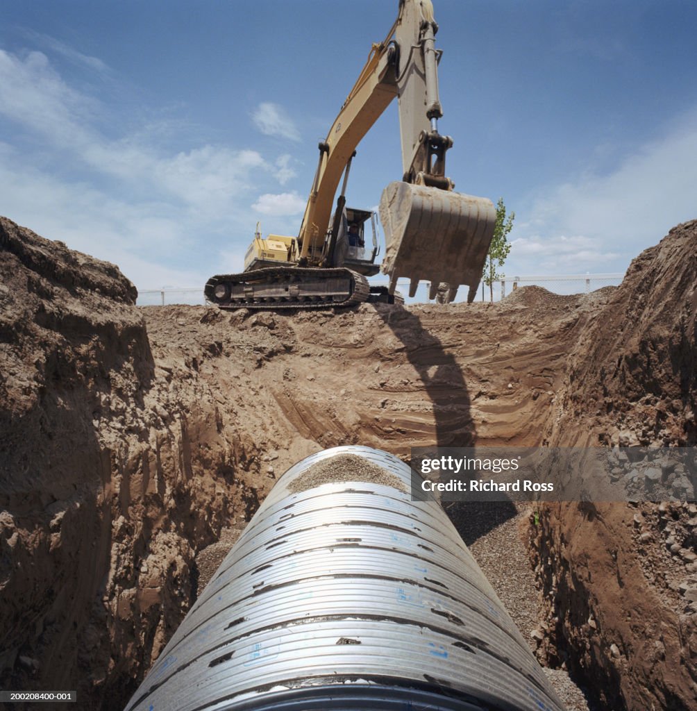 Overhead Digging Mechanical Digger Over Trench And Underground Pipe High-Res Stock Photo ...