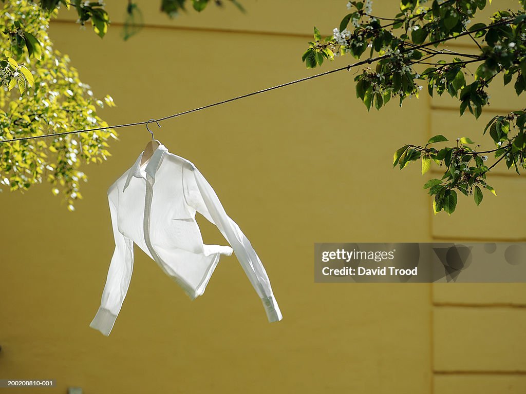 White shirt hanging on line, outdoors