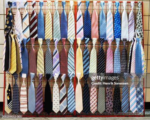 various ties displayed on rack - krawatte stock-fotos und bilder