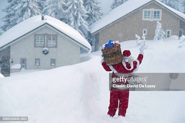 santa claus with gifts, rear view - santa waving stock pictures, royalty-free photos & images