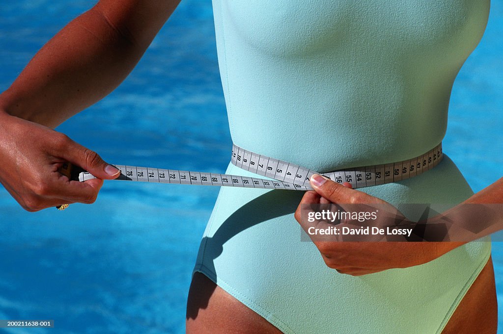 Woman with tape measure around waist