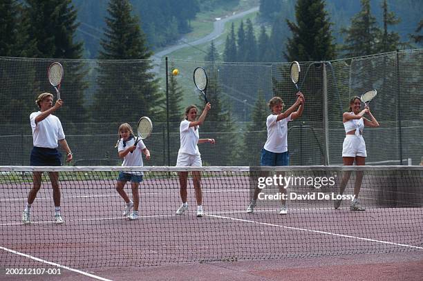 group playing tennis - tennis woman stockfoto's en -beelden