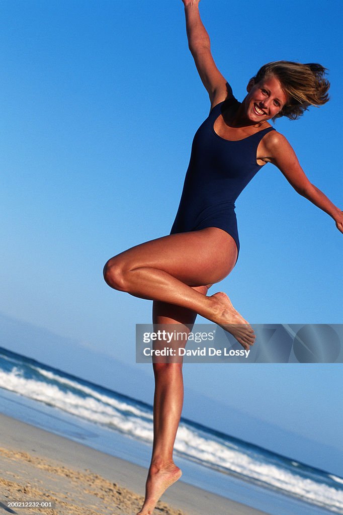 Young woman leaping at the beach