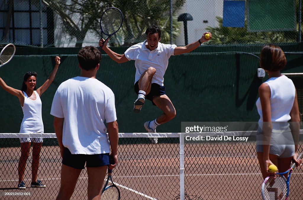 Men and women playing tennis, mixed doubles