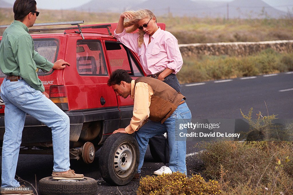 Man changing flat tyre