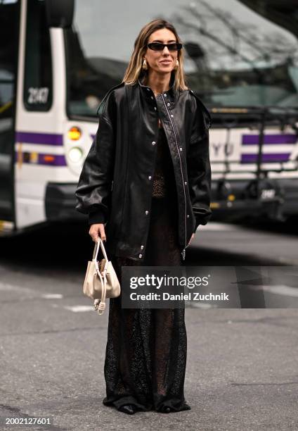 Hannah Lewis is seen wearing a black jacket, sheer black skirt and cream bag outside the LaPointe show during NYFW F/W 2024 on February 10, 2024 in...