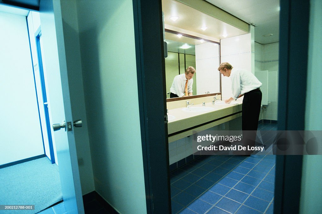 Man washing hand in bathroom