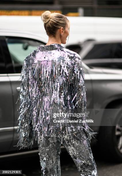 Guest is seen wearing a silver fringe top and pants outside the LaPointe show during NYFW F/W 2024 on February 10, 2024 in New York City.