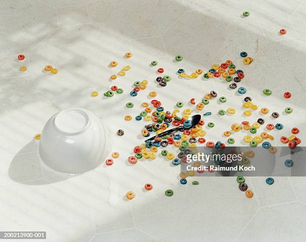 spilt bowl of cereal on white floor - spilt milk foto e immagini stock