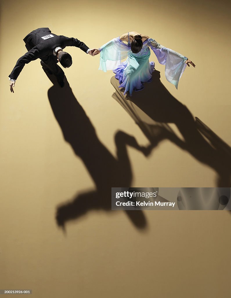 Young ballroom dancing couple bowing and curtseying, elevated view