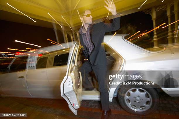 young man getting out of limousine, waving - car appearance stock pictures, royalty-free photos & images