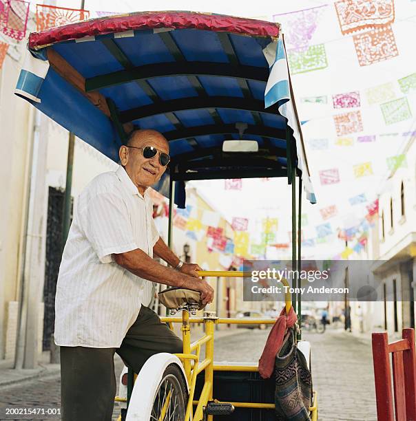 senior man stepping into pedicab - mexican bunting stock pictures, royalty-free photos & images